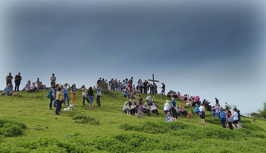 Cross on the hill with people